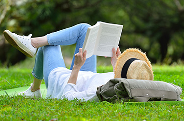 Reading a Book on the Grass